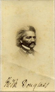 A historical sepia toned image of an older African American man, angled to the left, with black and white hair, a full mustache, and a dressy suit. Nineteenth century.